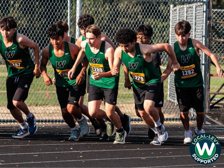 Boys cross country team lined up at start of race